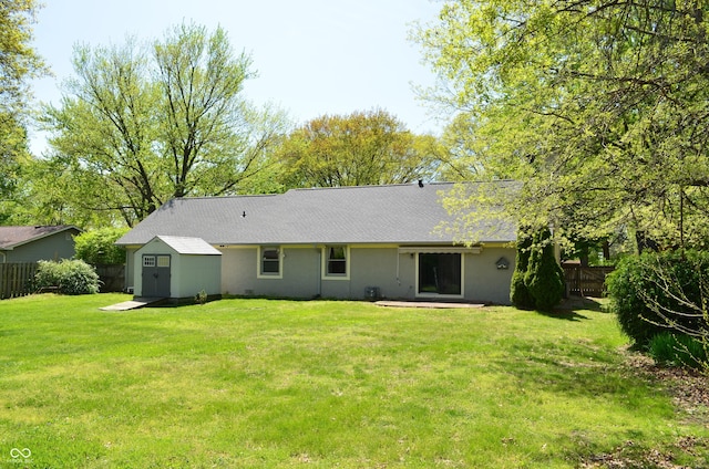 931 Beech Dr, Greenwood, IN 46142 - back of property with a storage shed, fence, an outdoor structure, and a lawn