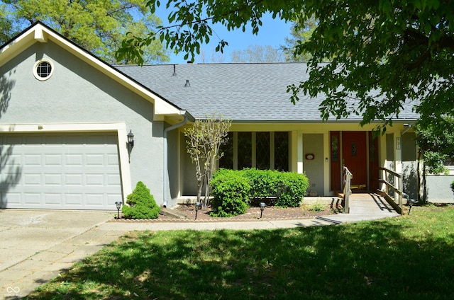 931 Beech Dr, Greenwood, IN 46142 - single story home with a garage, a front lawn, roof with shingles, stucco siding, and driveway