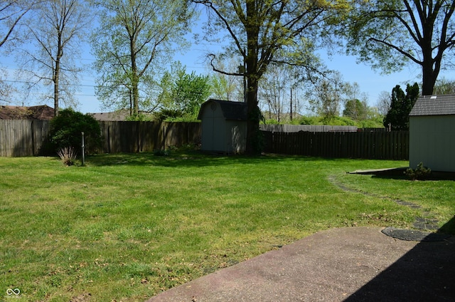 931 Beech Dr, Greenwood, IN 46142 - view of yard featuring an outdoor structure, a fenced backyard, and a storage unit