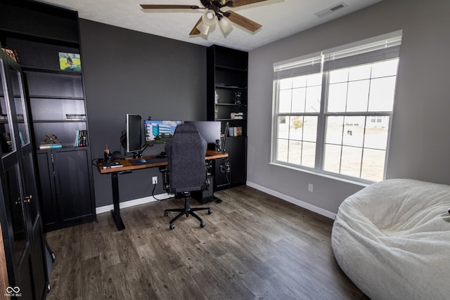 office area featuring baseboards, a ceiling fan, wood finished floors, and visible vents