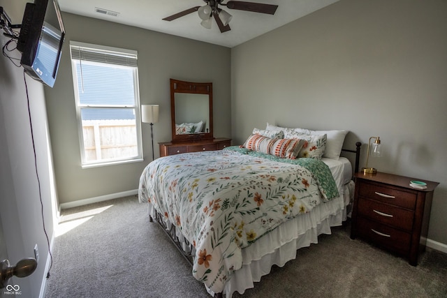 bedroom featuring baseboards, a ceiling fan, dark carpet, and visible vents