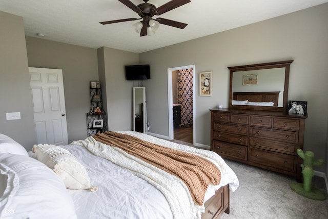 bedroom featuring connected bathroom, ceiling fan, and light carpet