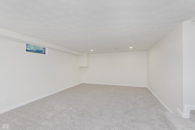 basement with baseboards, carpet flooring, recessed lighting, and a textured ceiling