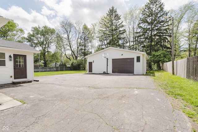 detached garage featuring fence