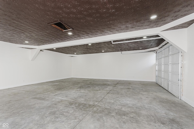 garage featuring recessed lighting and baseboards