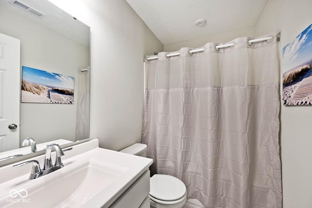 bathroom with visible vents, a shower with curtain, toilet, and vanity