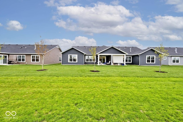 back of property with a lawn and a patio