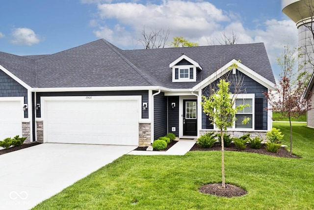 view of front of house featuring roof with shingles, a garage, a front lawn, concrete driveway, and stone siding