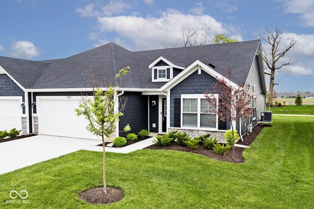 view of front of property with driveway, roof with shingles, a garage, central air condition unit, and a front lawn