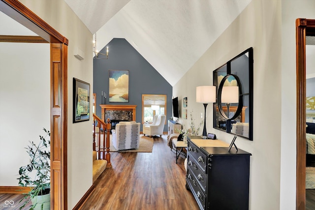 corridor featuring dark wood-type flooring, stairway, and high vaulted ceiling