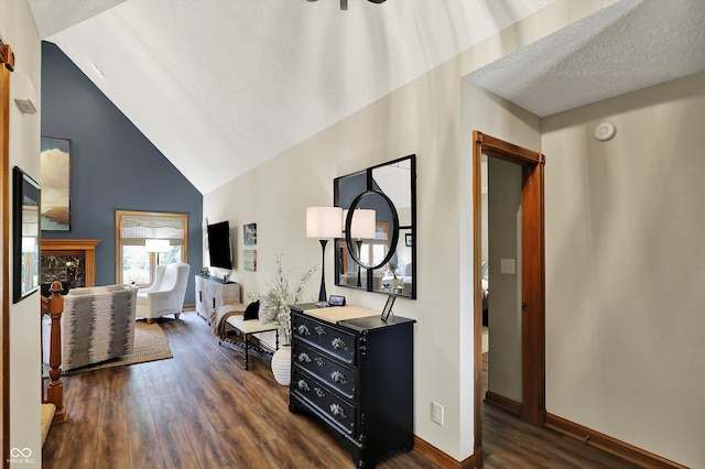 corridor with dark wood finished floors, vaulted ceiling, and baseboards