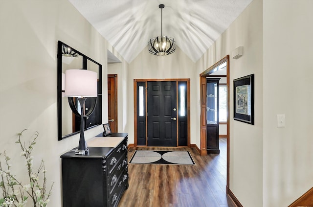 entryway with vaulted ceiling, dark wood-style flooring, and baseboards