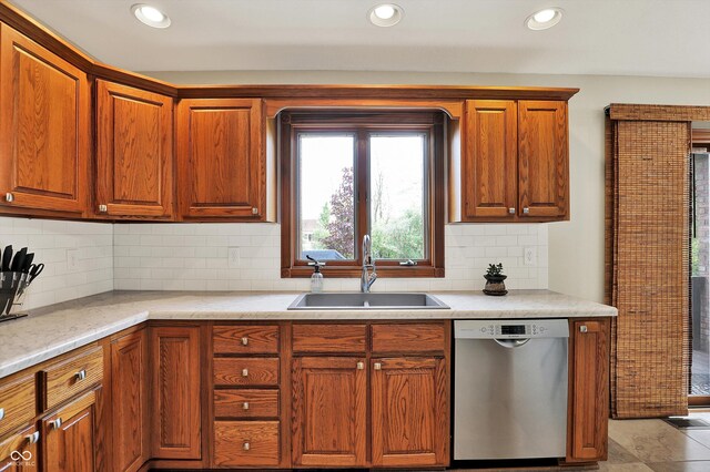 kitchen with recessed lighting, backsplash, stainless steel dishwasher, and a sink