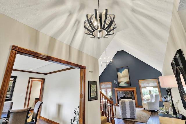 interior space featuring a premium fireplace, a chandelier, and baseboards