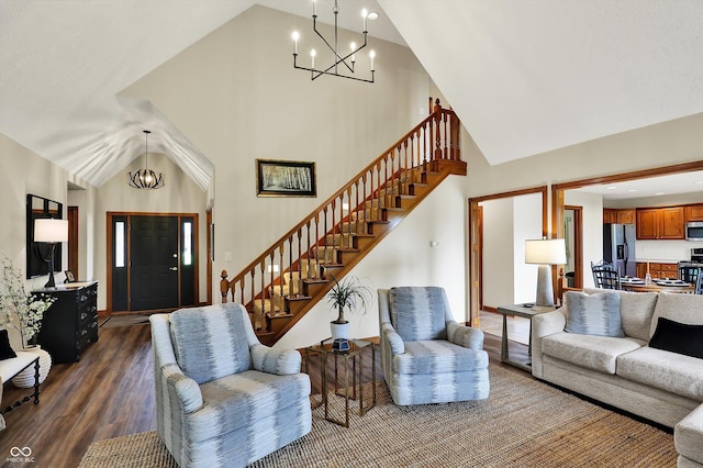 living area featuring high vaulted ceiling, stairs, a notable chandelier, and dark wood-style floors