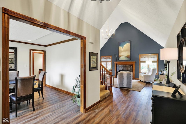 interior space featuring baseboards, a chandelier, high vaulted ceiling, wood finished floors, and stairway