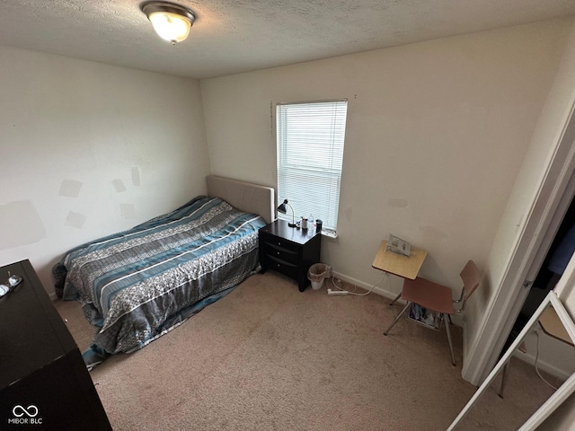 bedroom with carpet and a textured ceiling