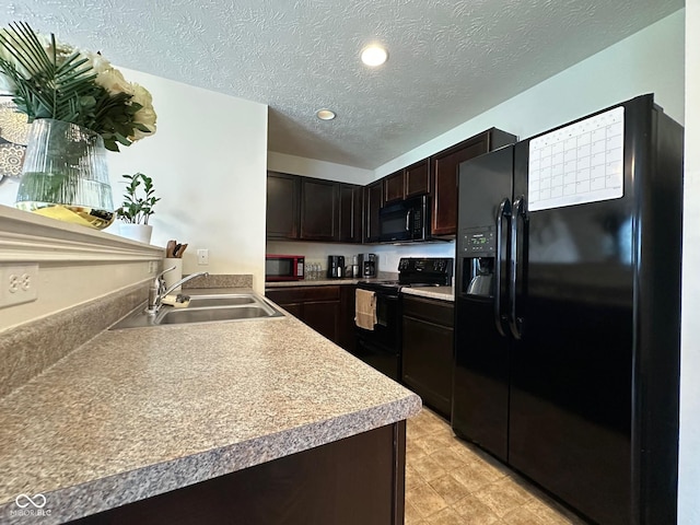 kitchen featuring dark brown cabinetry, a textured ceiling, a sink, light countertops, and black appliances