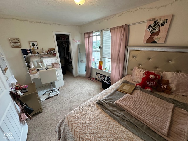 bedroom featuring light carpet and a textured ceiling