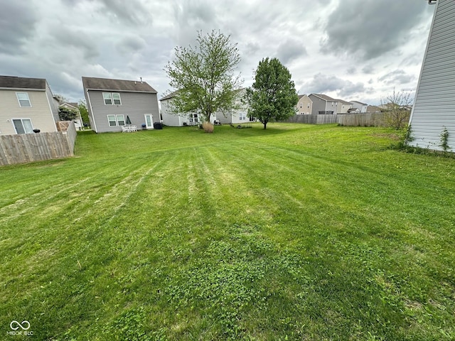view of yard with fence and a residential view