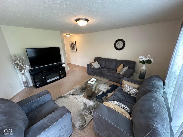 carpeted living room featuring baseboards and a textured ceiling