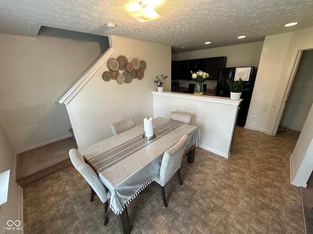 dining area featuring baseboards, recessed lighting, and a textured ceiling