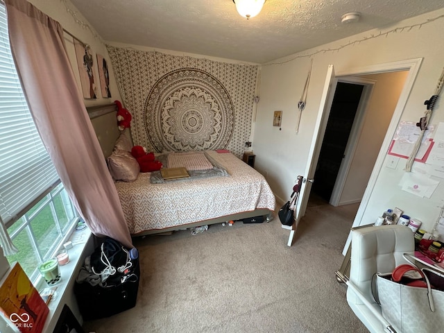 bedroom with carpet floors and a textured ceiling