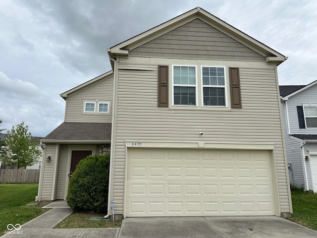 traditional-style house with an attached garage and driveway