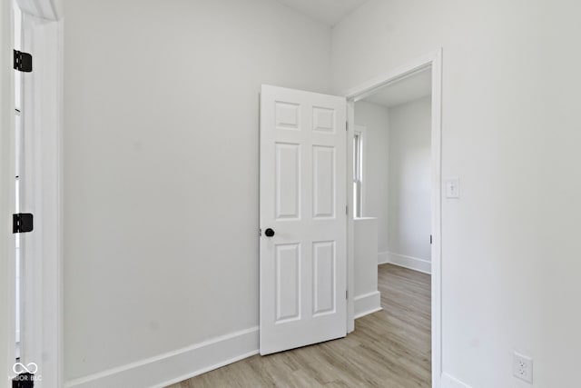 empty room featuring light wood-style floors and baseboards