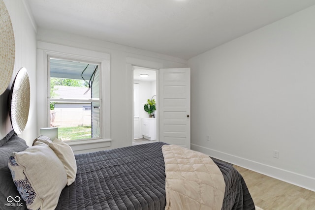 bedroom featuring baseboards and wood finished floors