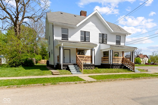 view of front of home with covered porch, roof with shingles, a chimney, and a front yard