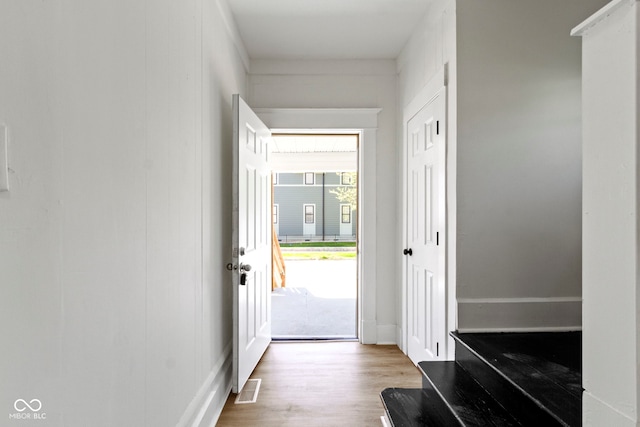 doorway to outside featuring visible vents and wood finished floors