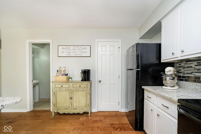162 Carmelaire Dr, Carmel, IN 46032 - kitchen with tasteful backsplash, light wood-style flooring, white cabinetry, and freestanding refrigerator