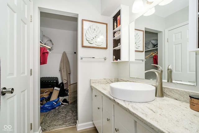 162 Carmelaire Dr, Carmel, IN 46032 - bathroom with vanity, wood finished floors, and a spacious closet