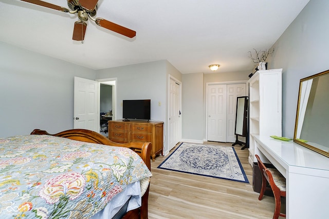 162 Carmelaire Dr, Carmel, IN 46032 - bedroom featuring light wood-style flooring, ceiling fan, and multiple closets