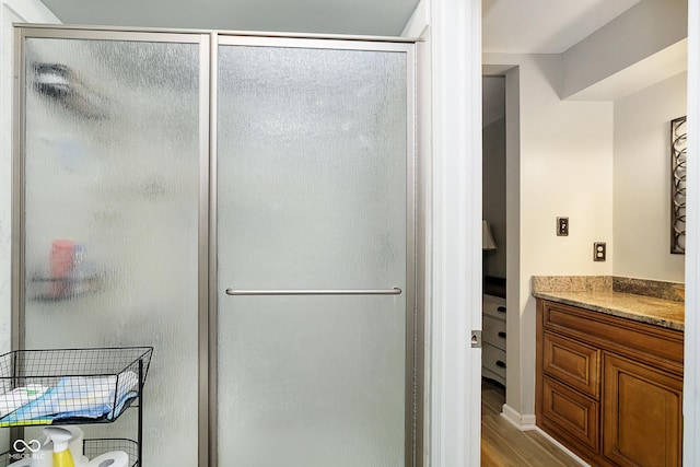 162 Carmelaire Dr, Carmel, IN 46032 - bathroom featuring a stall shower, vanity, and wood finished floors
