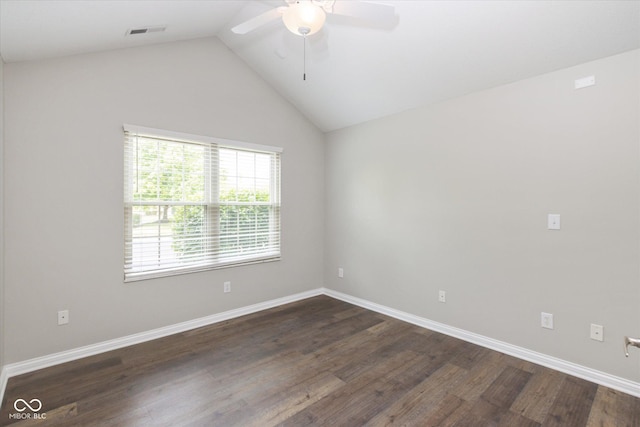 spare room featuring a ceiling fan, vaulted ceiling, dark wood finished floors, and baseboards