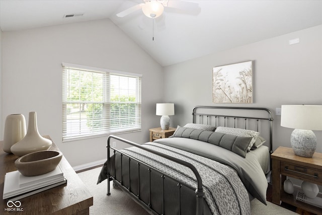bedroom featuring lofted ceiling, baseboards, and a ceiling fan