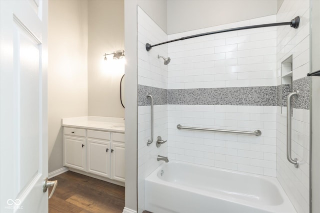 bathroom with wood finished floors, vanity, and tub / shower combination