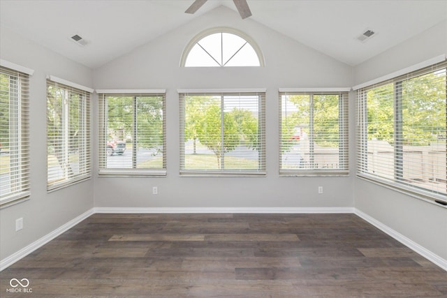 unfurnished sunroom with vaulted ceiling, wood finished floors, and baseboards