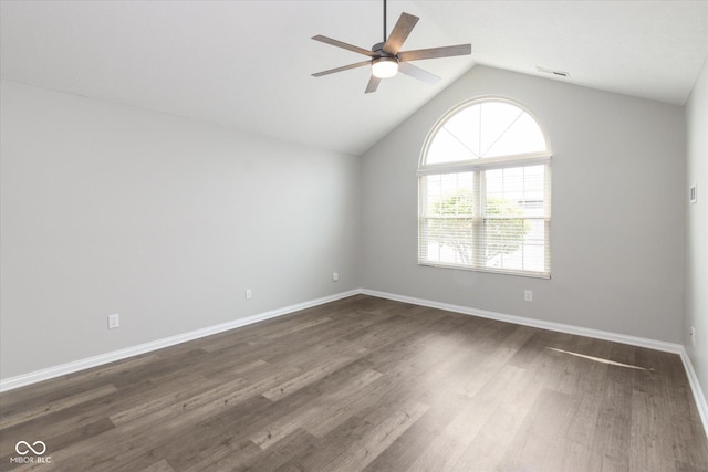unfurnished room featuring ceiling fan, vaulted ceiling, dark wood-style floors, and baseboards