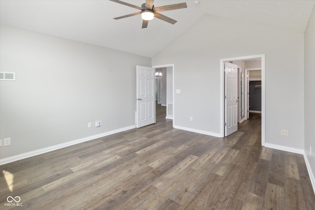 unfurnished bedroom with high vaulted ceiling, baseboards, a spacious closet, dark wood-type flooring, and ceiling fan