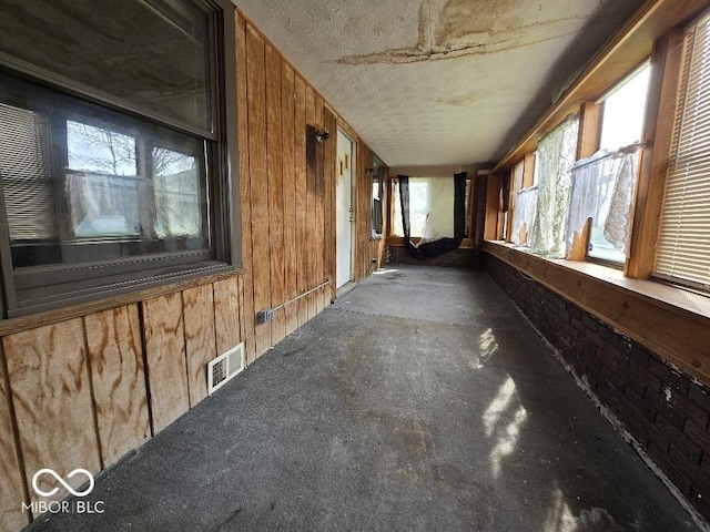 1354 Roache St, Indianapolis, IN 46208 - interior space featuring wooden walls, a textured ceiling, visible vents, and carpet
