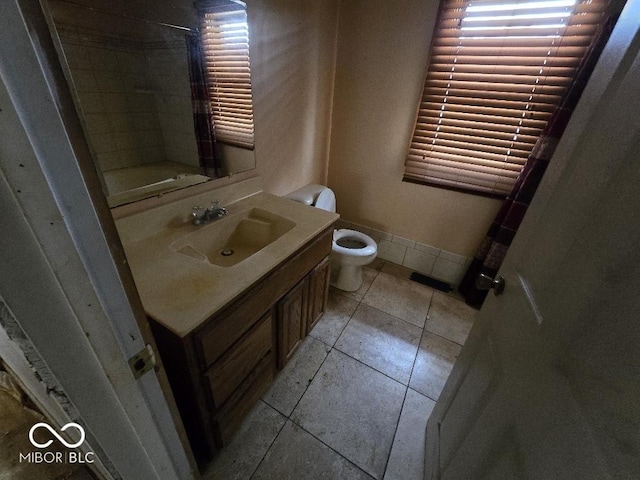 1354 Roache St, Indianapolis, IN 46208 - bathroom featuring tile patterned flooring, vanity, toilet, walk in shower, and plenty of natural light