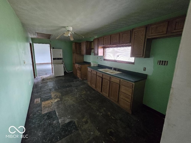 1354 Roache St, Indianapolis, IN 46208 - kitchen with brown cabinets, dark countertops, a sink, a textured ceiling, and a ceiling fan