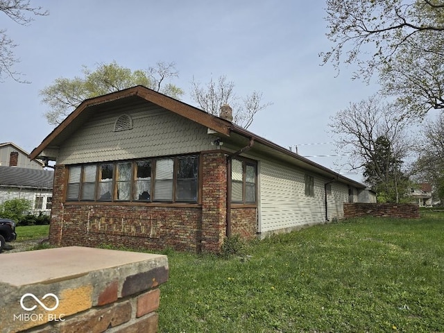 1354 Roache St, Indianapolis, IN 46208 - view of home's exterior featuring a lawn, brick siding, and a chimney