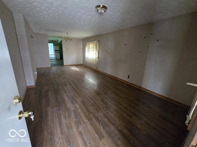 1354 Roache St, Indianapolis, IN 46208 - unfurnished room with a textured ceiling, baseboards, wood finished floors, and a notable chandelier