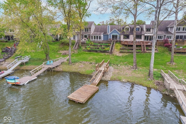 view of dock featuring stairway, a yard, a residential view, and a deck with water view