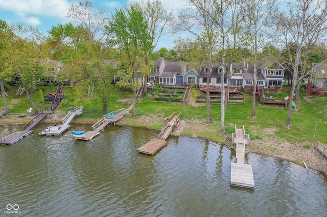 dock area with stairs, a yard, and a deck with water view