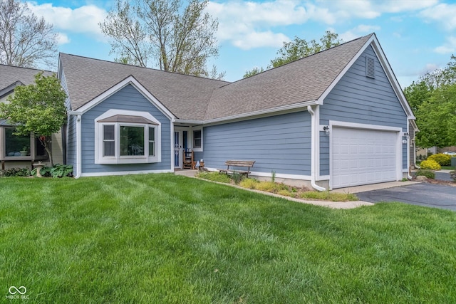 single story home with a garage, a front lawn, roof with shingles, and aphalt driveway